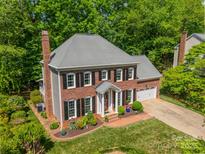Beautiful brick two-story home featuring manicured lawn and an attached two-car garage at 14926 Chilgrove Ln, Huntersville, NC 28078