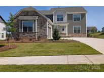 Charming two-story home with a stone and gray siding exterior and well-manicured front lawn at 2084 Fordhill St, Rock Hill, SC 29732