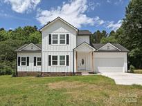 Charming two-story home with white siding, black shutters, and a well-manicured lawn at 240 Doster Rd, Lancaster, SC 29720