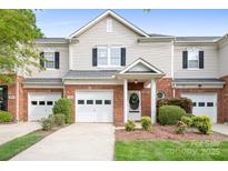 Charming townhome with brick accents, well-manicured landscaping, and a single-car garage at 3906 Thomas Ridge Dr, Charlotte, NC 28269