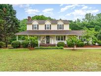 Inviting two-story home with a covered porch, lush landscaping, and a well-maintained lawn at 6769 Highway 557 None, Clover, SC 29710