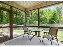 Screened-in patio with table and chairs, perfect for enjoying the outdoors at 10340 Williams Rd, Mint Hill, NC 28227