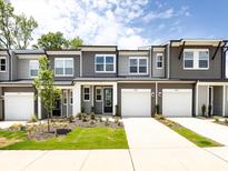 Charming new townhomes with attached garages and modern gray siding at 2021 Endeavor Run, Charlotte, NC 28269