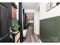 Welcoming entryway featuring modern wood-look floors and stylish wainscoting, leading into a bright, open living space at 330 Hyssop Ct, Fort Mill, SC 29715