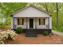 Charming home with a cozy front porch, black shutters, and a well-manicured yard at 905 Gantt St, Kings Mountain, NC 28086