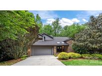 Charming home with a well-maintained lawn, mature trees, and a two-car garage at 9310 Hunting Ct, Matthews, NC 28105