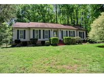 Charming single-story home featuring classic siding, a well-manicured lawn, and dark shutters, offering timeless curb appeal at 10708 Danesway Ln, Cornelius, NC 28031