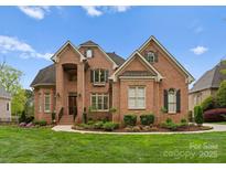 Beautiful brick home with manicured lawn and landscaping creates inviting curb appeal at 13420 Robert Walker Dr, Davidson, NC 28036