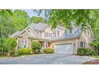 Charming two-story home with stone accents, well-manicured landscaping, and attached two car garage at 19729 Callaway Hills Ln, Davidson, NC 28036
