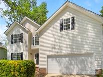 Charming two-story home with white siding, black shutters, and a two-car attached garage at 2405 Kalis Pl, Charlotte, NC 28262