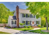 Charming two-story home with a brick chimney, well-maintained lawn, and inviting landscaping at 7300 Chatterbird Ct, Charlotte, NC 28226