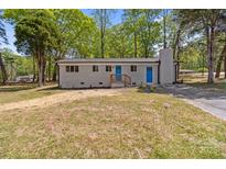 Charming single-story home with a brick chimney and a well-maintained lawn at 880 Legion Club Rd, Salisbury, NC 28146