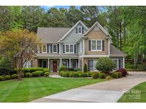Inviting two-story home featuring manicured landscaping and a welcoming front porch at 116 Anderson Farm Ct, Mooresville, NC 28117