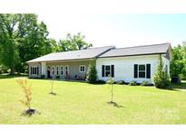 Charming single-story home with a well-manicured lawn and inviting front porch at 129 Devon Dr, Heath Springs, SC 29058