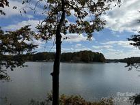 Scenic lake view with fall foliage and blue skies at 181 Asbury Cir, Mooresville, NC 28117