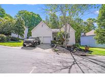 Charming home with an attached garage and beautifully landscaped front yard at 13817 Kings Carriage Ln, Charlotte, NC 28278