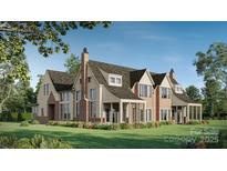 Stunning brick and siding home showcasing a manicured lawn and charming architectural details at 1636 Ferncliff Rd, Charlotte, NC 28211