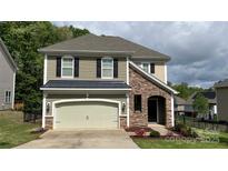 Charming home featuring stone accents, neutral siding, a two-car garage, and well-maintained landscaping at 3030 Collin House Dr, Fort Mill, SC 29715