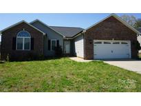 Charming single-story home featuring a brick facade, gray siding, and a well-maintained front yard at 4193 He Propst Rd, Maiden, NC 28650