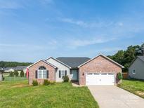 Charming brick and gray home featuring a two-car garage and manicured front lawn in a suburban setting at 4193 He Propst Rd, Maiden, NC 28650