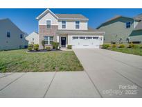 Charming two-story home with a well-manicured lawn, inviting curb appeal, and an attached two-car garage at 1210 Longwall Ln, Matthews, NC 28104