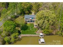 Stunning lakefront home with private dock and lush, mature landscaping at 1430 Mollys Backbone Rd, Catawba, NC 28609