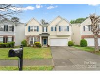 Charming two-story home with stone accents, blue shutters, well-manicured lawn and two car garage at 16219 Long Talon Way, Charlotte, NC 28273