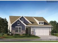 Charming two-story home boasts a mix of stone and siding, an attached two-car garage, and meticulously landscaped front yard at 1627 Spring Lot Dr, Edgemoor, SC 29712