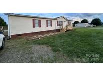 Charming single-Gathering home with vinyl siding and well-maintained lawn at 234 Olin Loop, Olin, NC 28660