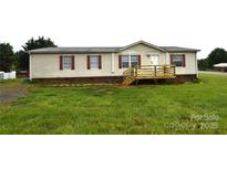 Charming single-story home featuring a quaint front porch and well-maintained lawn at 234 Olin Loop, Olin, NC 28660