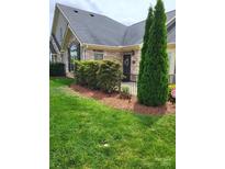 Charming home featuring a stone facade, manicured lawn, and tasteful landscaping for enhanced curb appeal at 2355 Villa Oaks Ct, Gastonia, NC 28054