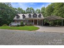 Charming brick home with a metal roof, covered porch, and convenient carport on a well-maintained lot at 32060A Flint Ridge Rd, Albemarle, NC 28001