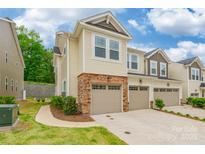 Charming townhome featuring a stone-accented facade, attached garage, and well-maintained landscaping at 3832 Amalia Pl, Indian Land, SC 29707