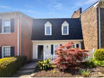 Charming townhome with a well-manicured front yard and a classic white picket fence at 8026 Regent Park Ln, Charlotte, NC 28210