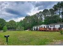 Charming single story home with a well-maintained lawn and a spacious wooden wheelchair ramp at 8813 Summerhill Dr, Waxhaw, NC 28173