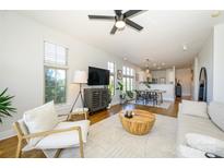 Bright living room featuring hardwood floors, an area rug, and natural light streaming through the windows at 1101 W 1St St # 405, Charlotte, NC 28202