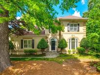 Charming exterior of a traditional home with manicured lawn and mature trees on a sunny day at 15618 Eagleview Dr, Charlotte, NC 28278
