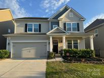 Charming two-story home with a well-maintained lawn and attached two-car garage at 2014 Burton Point Ct, Waxhaw, NC 28173