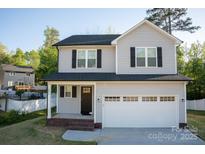 Charming two-story home featuring a two-car garage, covered front porch, and well-maintained landscaping at 206 N Kayla Dr, Salisbury, NC 28146