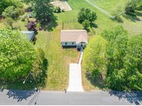 Expansive aerial view of a well-maintained home with a long driveway and a lush green lawn at 3121 Suffolk Dr, Shelby, NC 28152