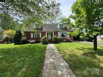 Charming brick home with a well-manicured lawn and a welcoming walkway at 404 S Mulberry St, Cherryville, NC 28021