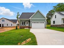 Charming green home with a two-car garage, landscaped yard, and long driveway in a new construction community at 424 Fulton Dr, Kings Mountain, NC 28086