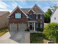 Beautiful two-story brick home featuring a two-car garage, manicured lawn, and a welcoming front porch at 4607 Bonroi Ave, Charlotte, NC 28213