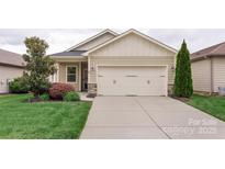 Charming home featuring a two-car garage, well-manicured lawn, and beautiful landscaping at 4991 Looking Glass Trl, Denver, NC 28037