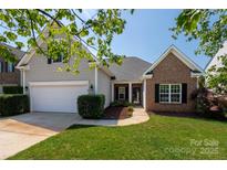 Charming two-story home with a well-manicured lawn, a two-car garage, and tasteful landscaping at 1004 Toquima Trl, Monroe, NC 28110