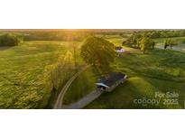 Beautiful aerial view of property showcasing the expansive green lawns and setting sun at 153 Coachman Loop, Statesville, NC 28625