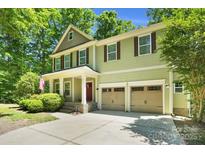 Charming two-story home with a well-manicured lawn, two-car garage, and inviting front porch at 2417 Labelle Dr, Waxhaw, NC 28173