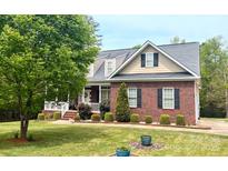 Charming brick home with a landscaped front yard, inviting porch, and manicured bushes at 3179 Westview Rd, Concord, NC 28025