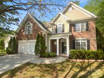 Charming two-story home featuring a brick facade, white trim, and a well-maintained lawn at 4035 Caldwell Ridge Pkwy, Charlotte, NC 28213