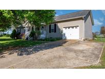 Charming single-story home with a well-maintained yard, driveway, and attached garage at 5184 Swinging Bridge Rd, Conover, NC 28613
